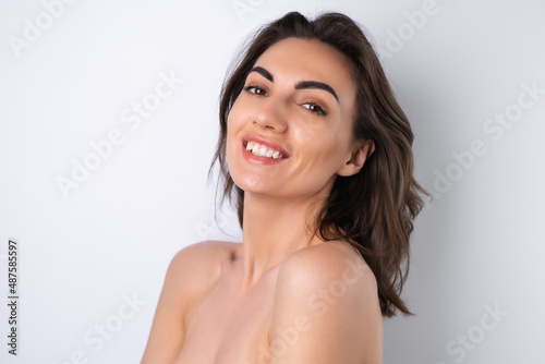 Close-up beauty portrait of a topless woman with perfect skin and natural make-up