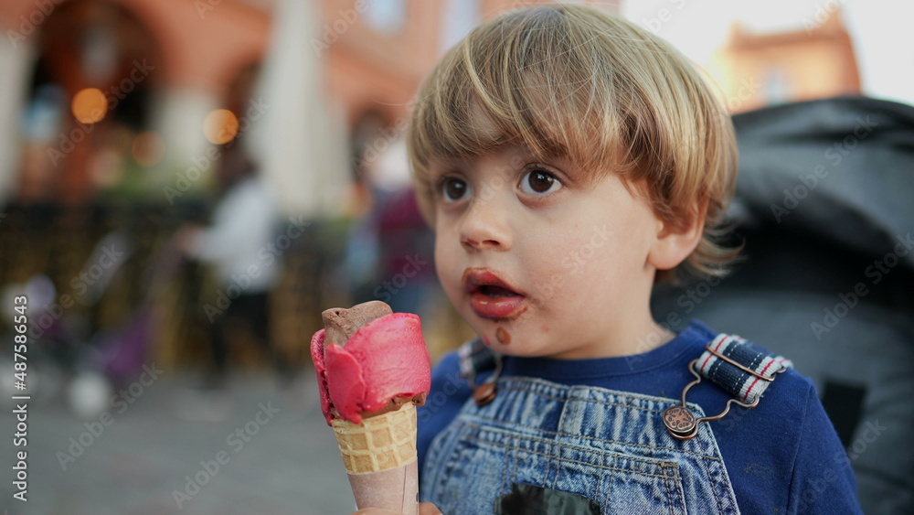 Little boy eating icecream child eats desert Little boy eating icecream child eats desert
