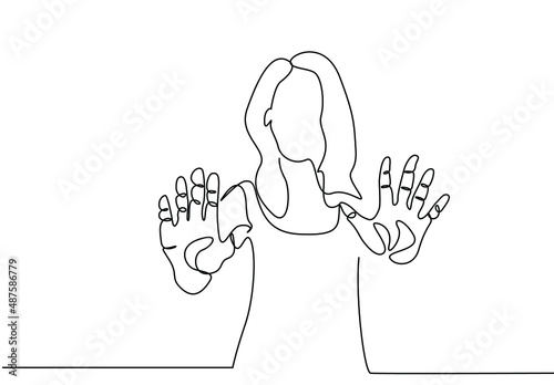 An anxious stressed woman making a stop sign