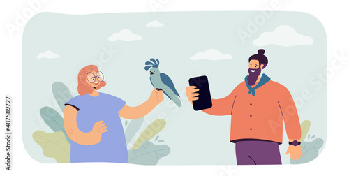 Man taking picture of girl with parrot flat vector illustration. Happy character paying for photo with wild animal. Violence concept for banner, website design or landing web page
