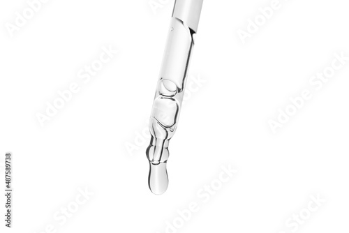 Liquid serum or water drop from laboratory glass pipette on white background with clipping path