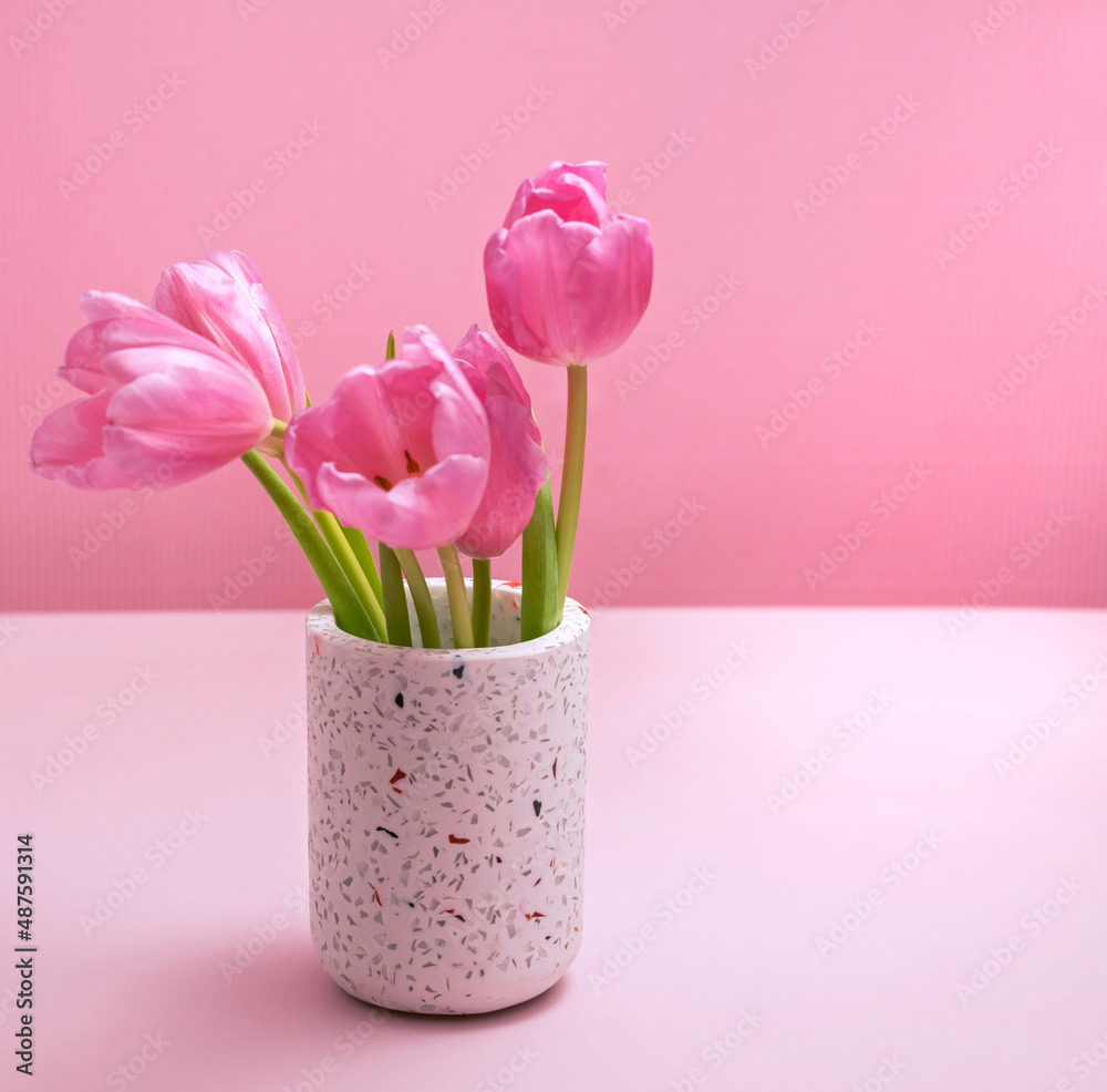 gentle spring background in pink with vase and tulips