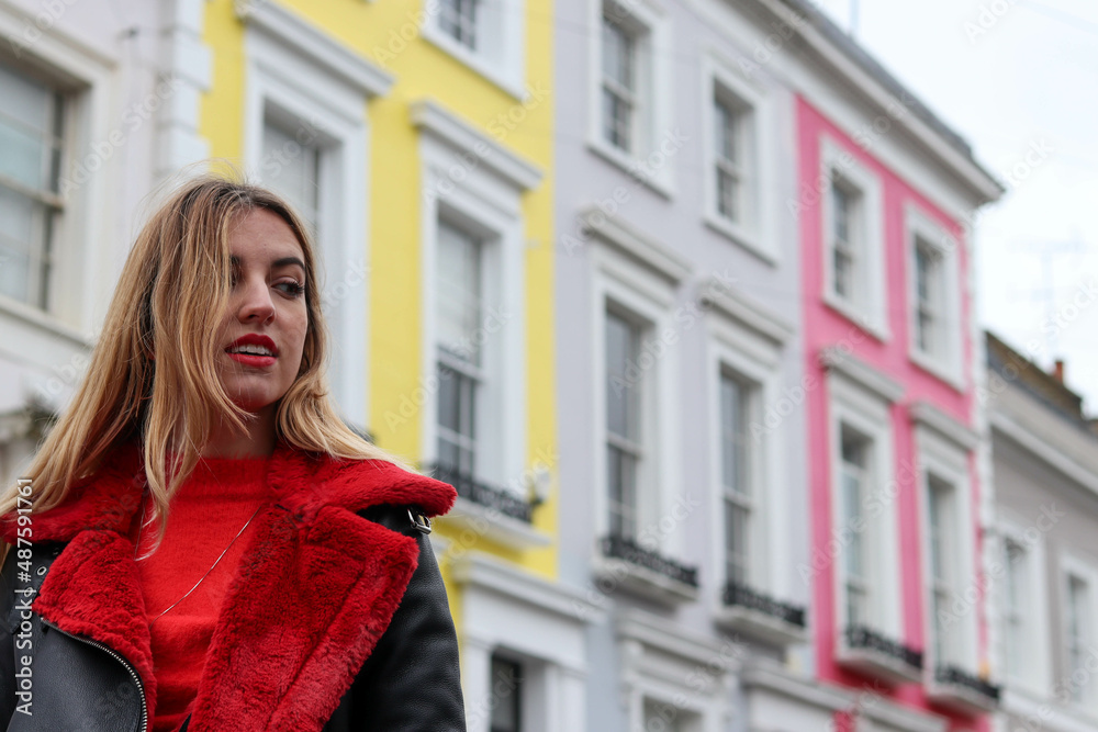 model in red coat in the colorful streets of london