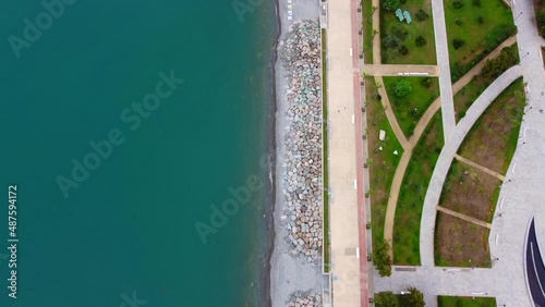Blue waves crashing on beach Aerial view waves break on a pebbly beach. Sea waves on the beautiful beach, aerial view drone shot. Amazing nature seascape