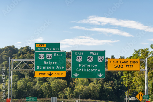 Road signs in Athens, Ohio on Route US 33 for Exit 197 A-B for Belpre, Stimson Ave and continuing on Routes US 33, US 50 and Ohio 32 photo
