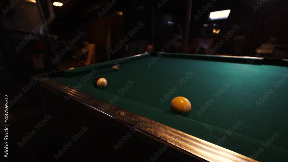 Choppy motion pan of a pool table during play.