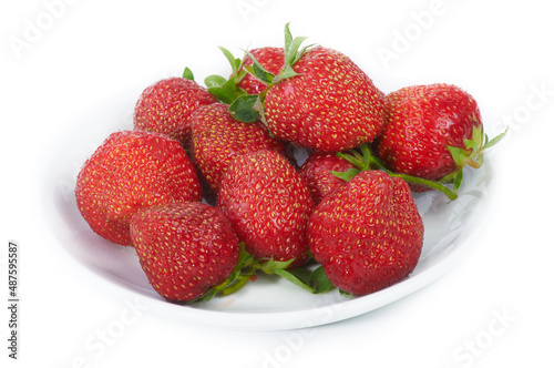 Fresh strawberries on a white plate, on a white background. Close up.