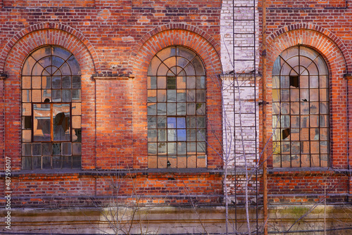 Old red brick factory, old architecture of the city of Lodz, Poland. Abandoned factory  photo