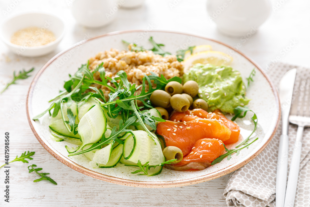 Oatmeal with salted salmon, avocado guacamole and fresh vegetable salad of arugula, cucumbers and olives. Breakfast Oatmeal with salted salmon, avocado guacamole and fresh vegetable salad of arugula, cucumbers and olives. Breakfast