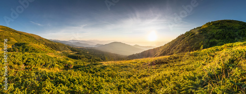 Sunrise at the top of Carpathian mountains, awesome nature landscape in the morning. Outdoor activity. Top of the mountains, lush lower parts.