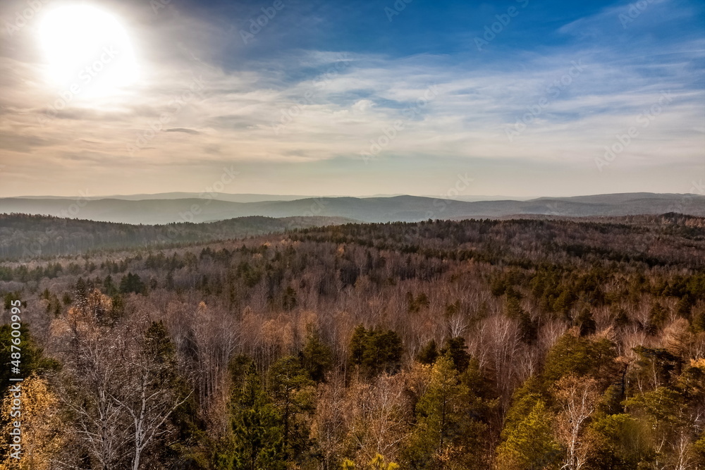 Autumn landscape from the top of a mountain with forest and sky