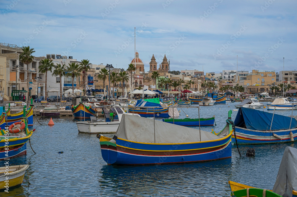 Traditional colorful fishing boats in the harbor of fishing village Marsaxlokk, Malta