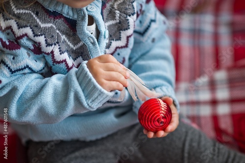 Childrens hands hold a Christmas tree toy 3706.