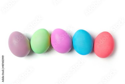 Multi-colored eggs on white background photo