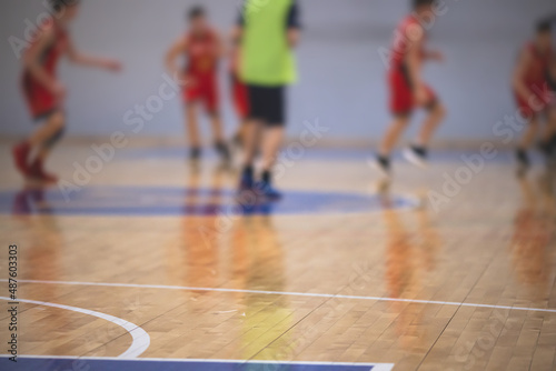 View of basketball court hall indoor venue with junior teenage school team playing in the background, basketball match game on arena stadium, team is blurred with copy space © tsuguliev