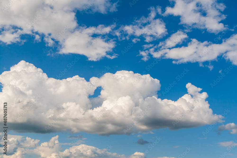 Fototapeta premium Clouds are white-maned horses. Blue sky with white clouds.