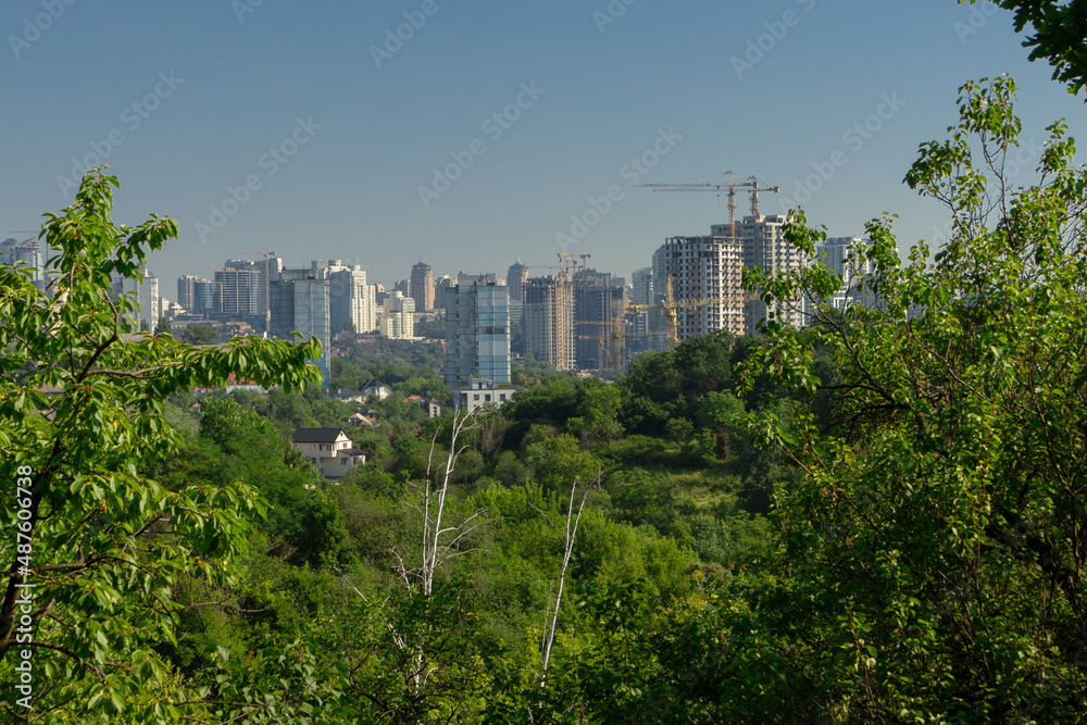 Fototapeta premium City next to the forest. Construction of residential buildings near the forest