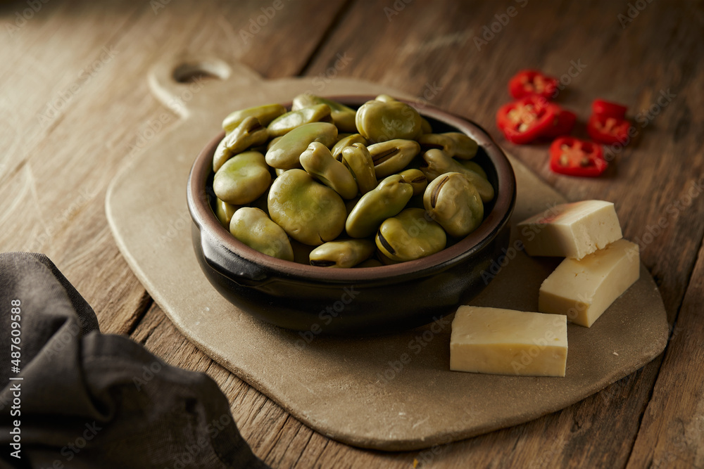 Broad beans with cheese, traditional Ecuadorian appetizer served in a typical deep dish with a traditional and culinary background
Broad beans with cheese, traditional Ecuadorian appetizer served in a typical deep dish with a traditional and culinary background