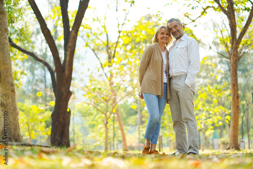 Portrait of happy elderly couple take care and love with good relationship health and romantic in the park as retirement insurance and lovely couple concept © KomootP