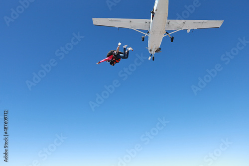 Skydiving. Tandem jump. The falling in the blue sky.