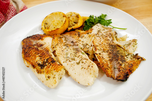 Fresh Tilapia Cooked with Butter and Herbs, Served with Lemon Slices 