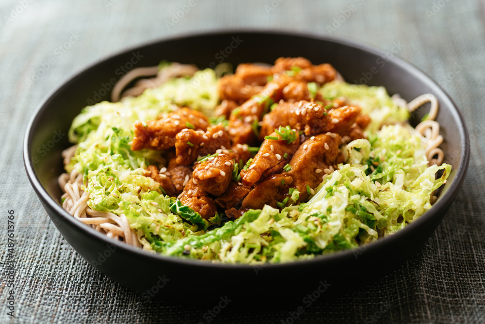 Spicy soy curls on shredded savoy cabbage, served with buckwheat noodles. Spicy soy curls on shredded savoy cabbage, served with buckwheat noodles.