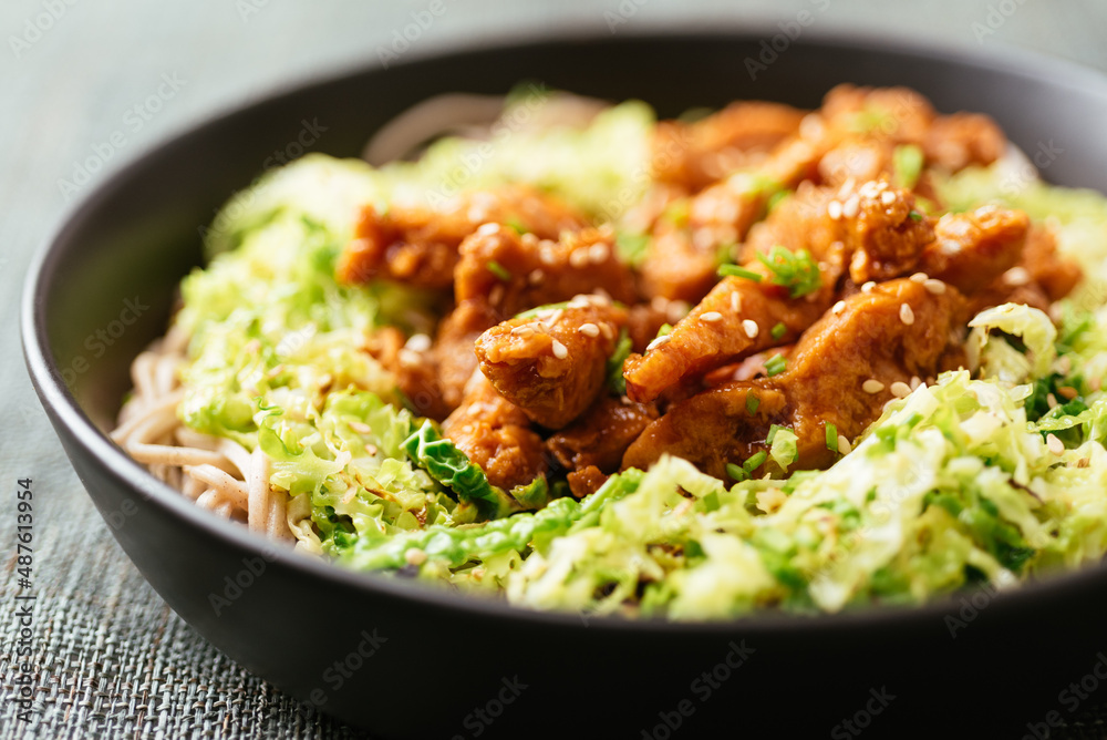 Spicy soy curls on shredded savoy cabbage, served with buckwheat noodles. Spicy soy curls on shredded savoy cabbage, served with buckwheat noodles.