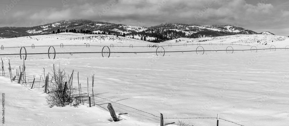 Fototapeta premium farm irrigation system with wheels in snowy field