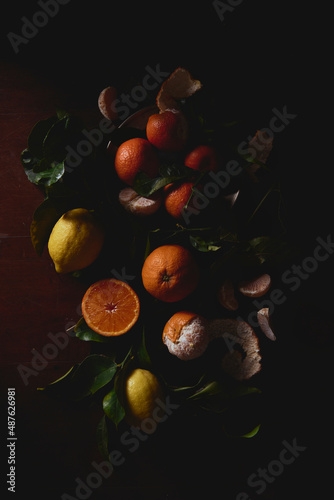 dark lemon orange citrus fruits dark still life on a wood table