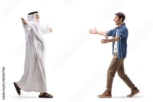 Full length profile shot of an arab man walking with open arms towards a young man