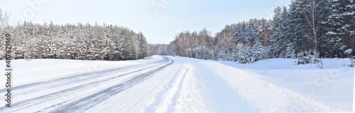 Panorama winter snow-covered road and forest