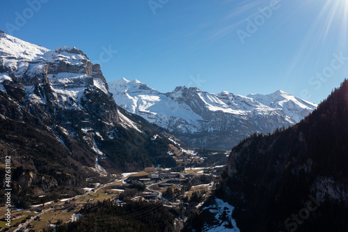 Amazing shot of a beautiful landscape in the alps of Switzerland. Wonderful flight with a drone over an amazing landscape in the canton of Bern. Epic view over a lake called Blausee. © Philip