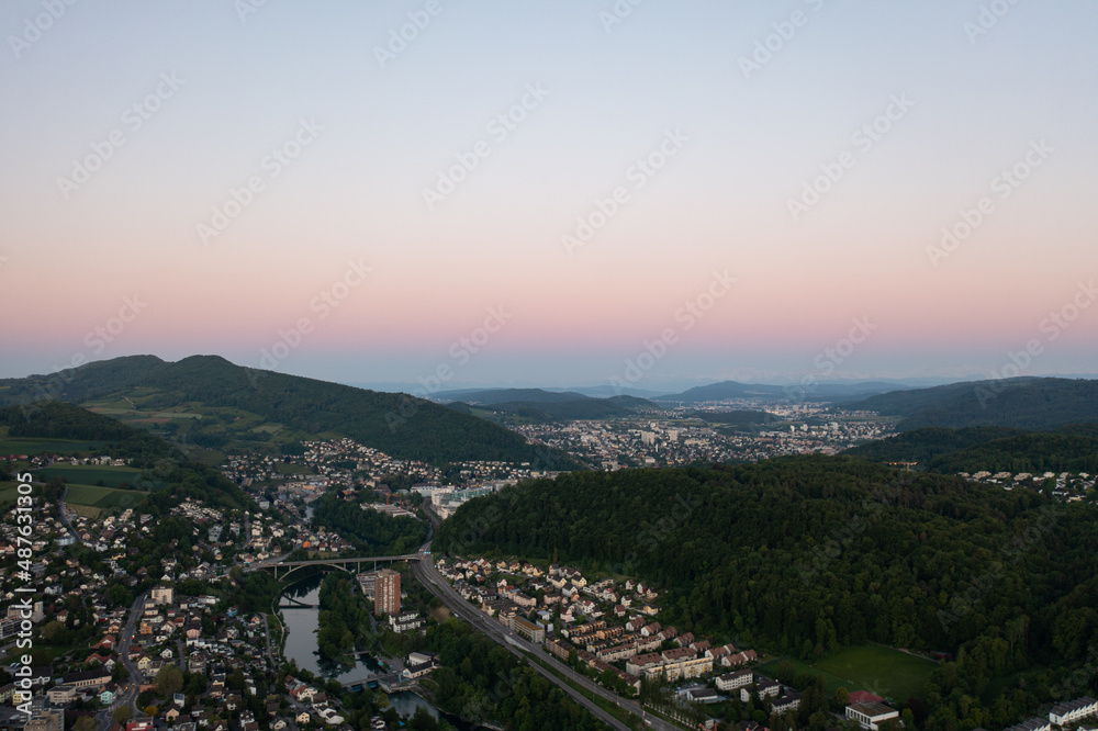 Amazing shot of a beautiful landscape in the alps of Switzerland. Wonderful flight with a drone over an amazing landscape in the canton of Aargau. Epic view at sunset over a village called Nussbaumen.