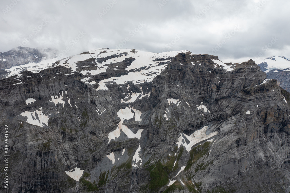 Obraz premium Amazing shot of a beautiful landscape in the alps of Switzerland. Wonderful flight with a drone over an amazing landscape in the canton of Glarus. Epic view over a lake called Limmerensee.