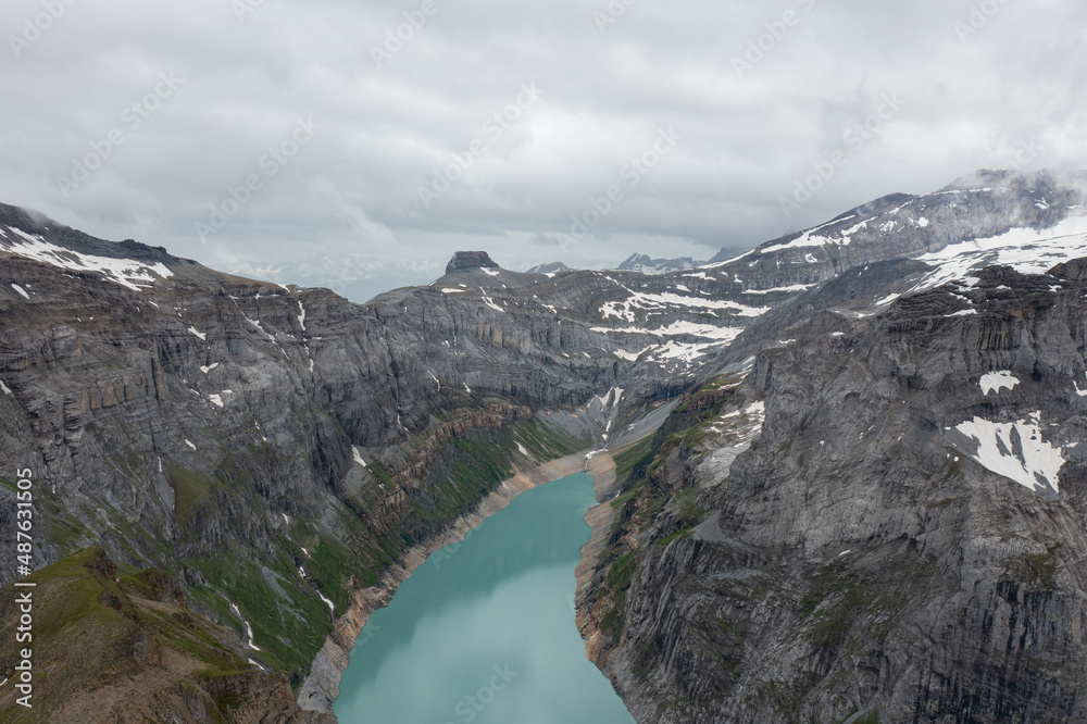 Amazing shot of a beautiful landscape in the alps of Switzerland. Wonderful flight with a drone over an amazing landscape in the canton of Glarus. Epic view over a lake called Limmerensee.