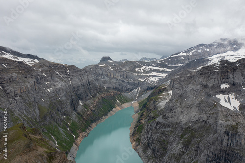 Fototapeta Naklejka Na Ścianę i Meble -  Amazing shot of a beautiful landscape in the alps of Switzerland. Wonderful flight with a drone over an amazing landscape in the canton of Glarus. Epic view over a lake called Limmerensee.