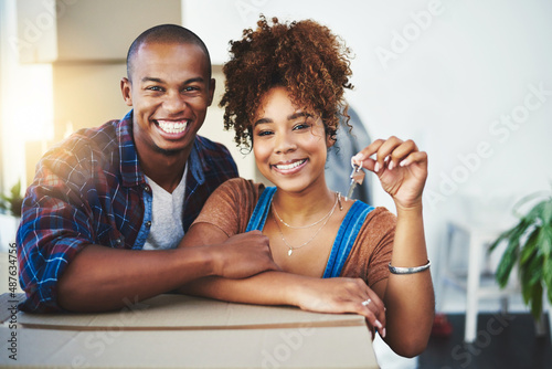 Starting our future together with this key. Shot of an attractive young couple moving house.
