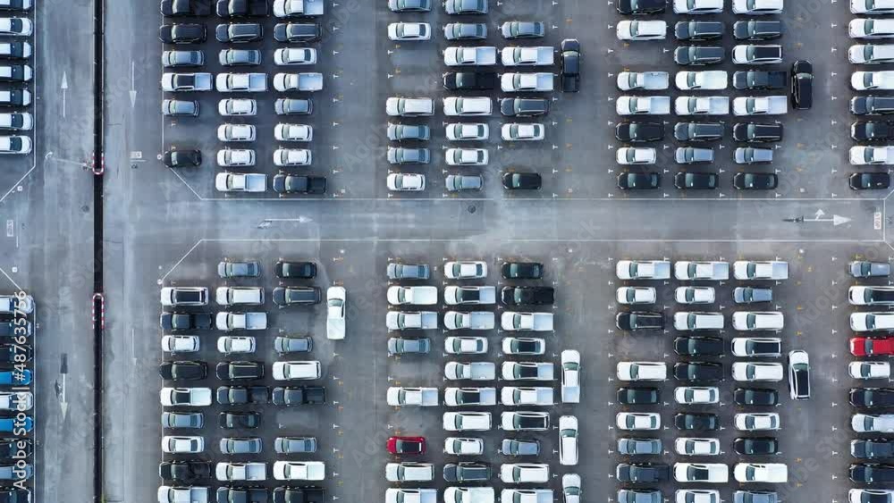 Aerial view from bottom to top New cars are produced from a car factory parked in a large number of parking lots to prepare for export abroad Aerial view from bottom to top New cars are produced from a car factory parked in a large number of parking lots to prepare for export abroad