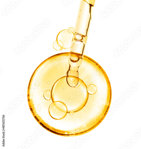 golden miracle yellow bubble vitamin oil or serum isolated on white background with laboratory glass pipette on white background. Beauty and skincare