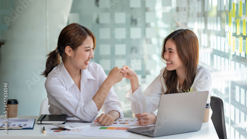 Fist bump. Teamwork of successful business people. Young Asian businesswoman or intern who successfully completes her goals.