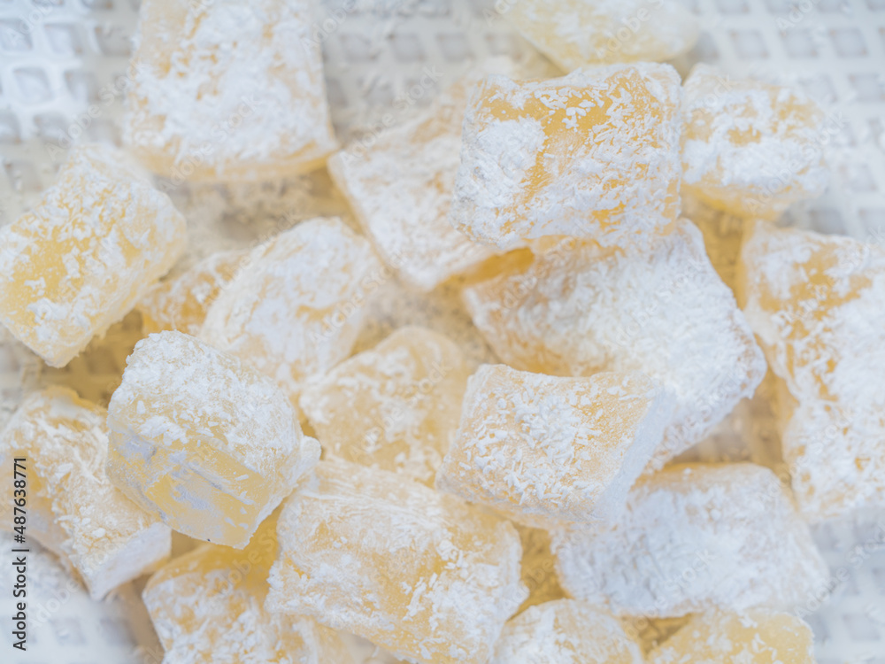 traditional turkish and greek jelly candy in powdered sugar on a plate. confectionery in Arabic style. Close-up..Turkish Delight . The concept of recipes, traditional cooking. traditional turkish and greek jelly candy in powdered sugar on a plate. confectionery in Arabic style. Close-up..Turkish Delight . The concept of recipes, traditional cooking.