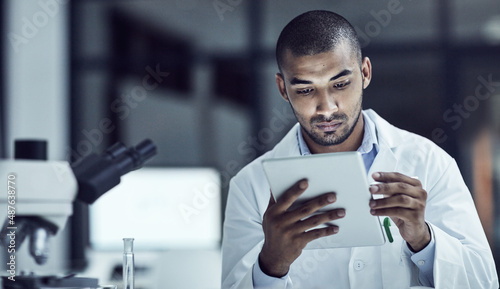 The use of electrical medical records increases. Shot of a scientist recording his findings on a digital tablet.