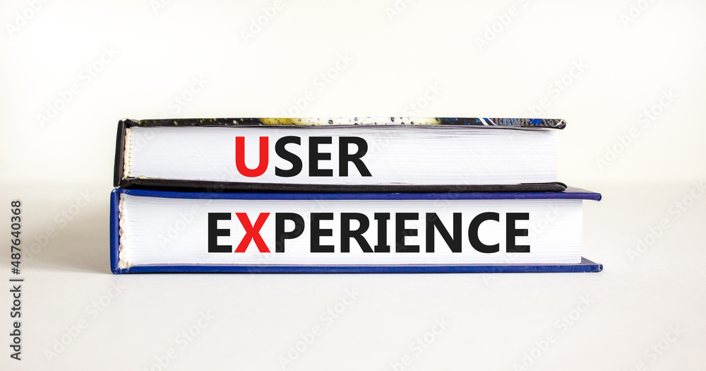 UX user experience symbol. Concept words UX user experience on books on a beautiful white table white background, copy space. Business and UX user experience concept.