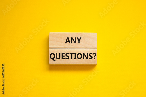 Any questions symbol. Concept words Any questions on wooden blocks on a beautiful yellow table yellow background. Business and Any questions Q and A concept, copy space.