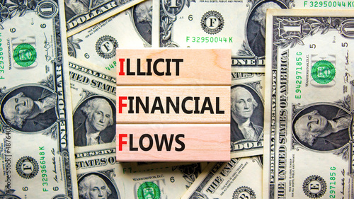 IFF illicit financial flows symbol. Concept words IFF illicit financial flows on wooden blocks on beautiful background from dollar bills. Business and IFF illicit financial flows concept. Copy space.