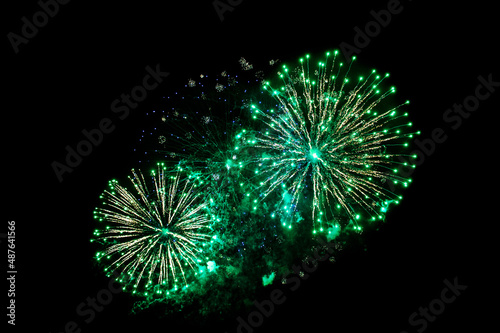 green fireworks on a black background. Festive Christmas lighting element for decoration. Sparks. Fireworks Are A Class Of Explosive Pyrotechnic Devices Used For Aesthetic Purposes. Isolated 