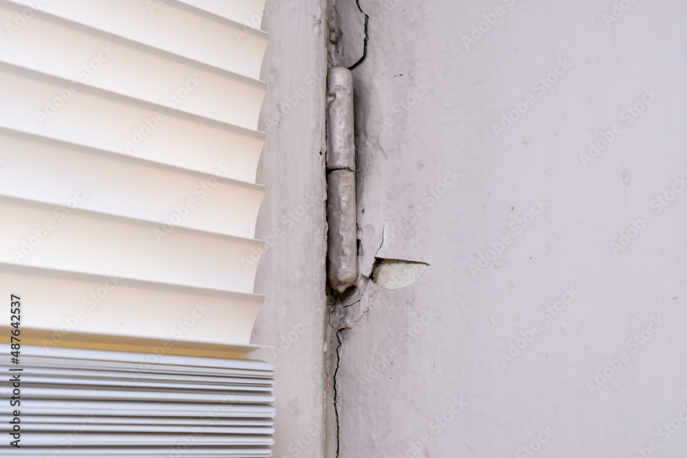 Peeling old paint on window slopes needed to be repared and repainted, reconstruction concept Peeling old paint on window slopes needed to be repared and repainted, reconstruction concept