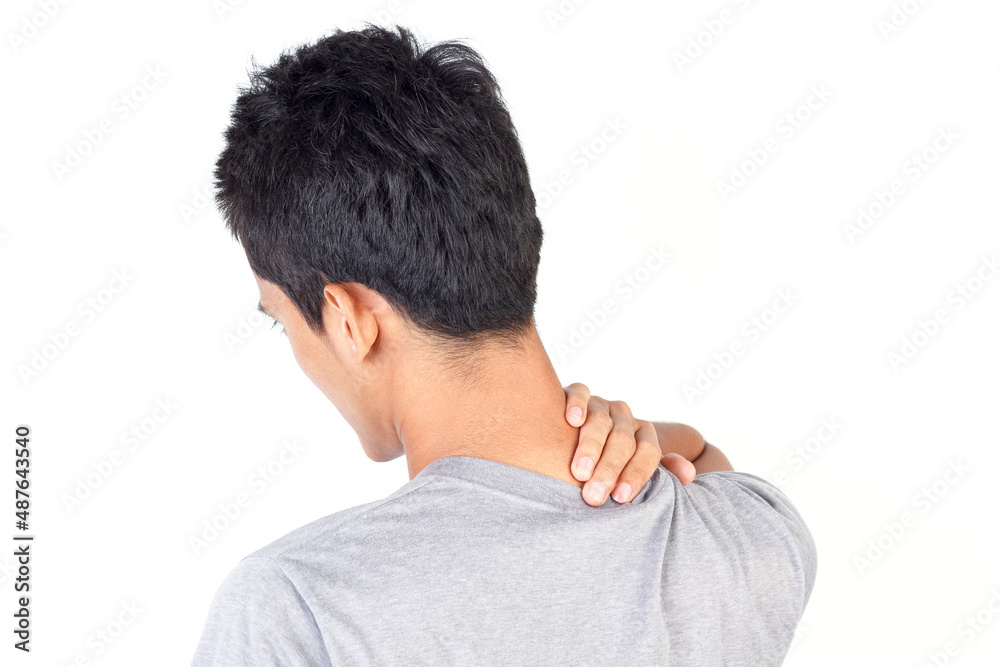 Young man wearing gray t-shirt suffering from pain in neck isolated on white background Young man wearing gray t-shirt suffering from pain in neck isolated on white background