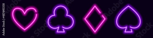 Glowing neon card suit symbols. Purple clubs and spades for a gambling poker game. Heart and diamonds for lucky vector win and jackpot