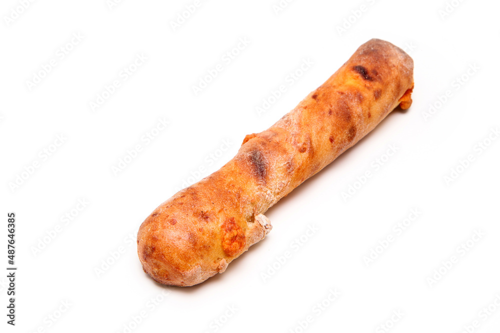 Single piece of bakery, the crunchy stick with mimolette cheese isolated in a white background. Single piece of bakery, the crunchy stick with mimolette cheese isolated in a white background.